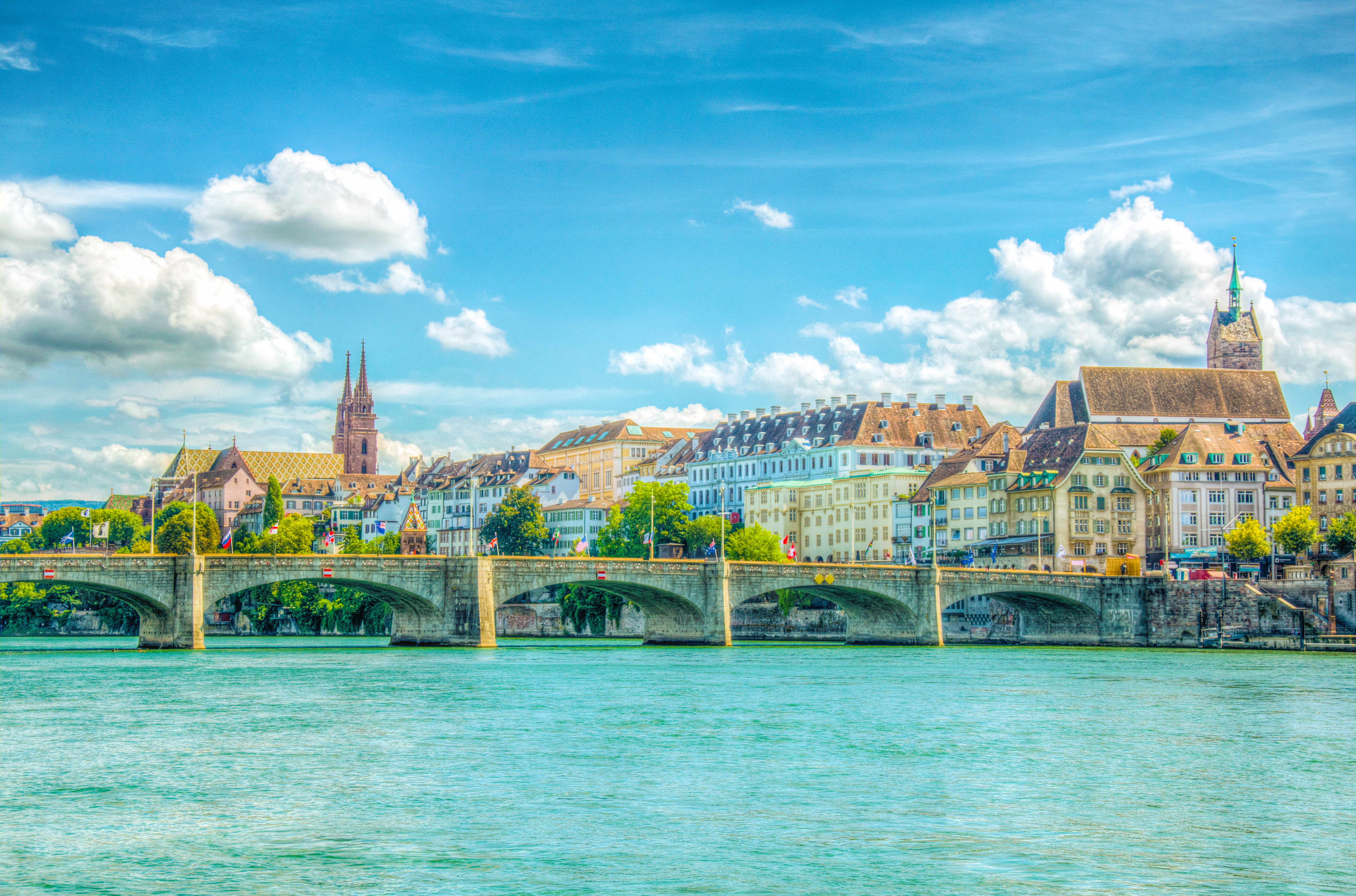 Basler Münster and Saint Martin church viewed behind the Mittlere Brücke in Basel, Switzerland. Photo by dudlajzov.